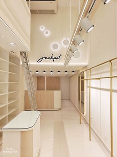 the interior of a retail store with white walls and gold trimmings on the ceiling