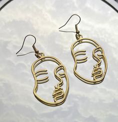 Gold Outlined Face Shaped Earring. Also available in Silver. Check out our other Face Shaped Earrings too! Everyday Artsy Earrings, Gold Artsy Earrings For Party, Artsy Gold Earrings For Party, Gold Artsy Drop Earrings, Artsy Gold Pierced Earrings, Artsy Gold Drop Earrings, Artsy Gold Metal Earrings, Artsy Gold Dangle Earrings, Artsy Gold Earrings With Ear Wire