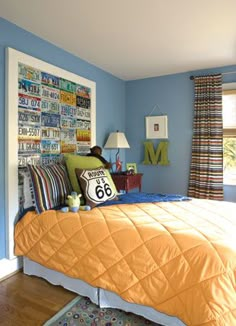 a bed room with a neatly made bed and blue walls