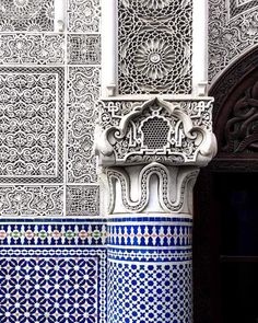 an ornate blue and white building with columns on the outside, decorated with intricate designs