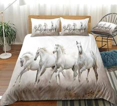 white horses running in the wind on a bedding set with pillows and throw blankets