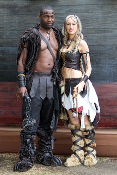 a man and woman dressed in costumes standing next to each other