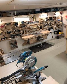 a room filled with lots of workbenches and tools on shelves next to each other