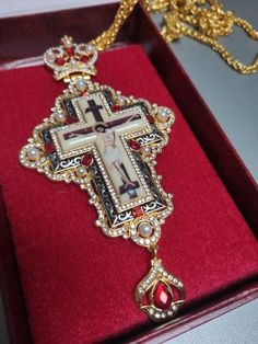 Orthodox pectoral cross, red stones cross for priest, brass chrest cross, pendant crucifix with golden Jesus, necklace religious gift idea Made of high-quality brass.  Decorated with red stones and pearls. Good gift idea for priests. Standard delivery abroad takes 2-3 weeks. So if You need a product from our shop as a gift for a special event, please, be ready that the whole process will take a few weeks. We can add the gift card to the order. Red Cross Pendant Necklace For Gift, Red Cross Pendant Necklace Gift, Red Crucifix Cross Necklace Gift, Red Crucifix Cross Necklace For Gift, Handmade Red Crucifix Jewelry, Cross Necklace With Large Pendant As A Gift, Large Pendant Cross Necklace As Gift, Large Pendant Cross Necklace For Gift, Gift Cross Necklace With Large Pendant