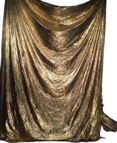 a gold cloth draped over the top of a chair