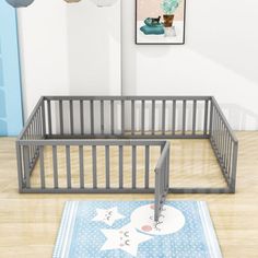 a baby crib in the corner of a room next to a rug with two bears on it