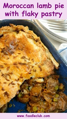 a close up of a pie in a pan with the words moroccan lamb pie with flaky pastry