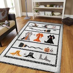 a living room with a rug on the floor that has halloween pictures and pumpkins all over it