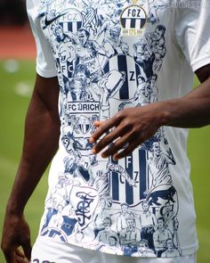 a close up of a person's shirt on a soccer field with other people in the background