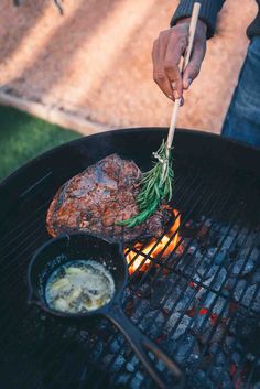 a person cooking food on top of a grill with tongs and a spatula