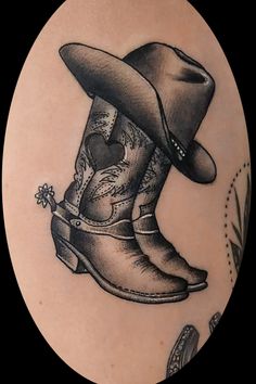 a tattoo with a cowboy boot and hat on it