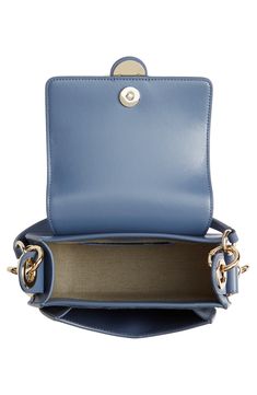 Gleaming pierced-ring hardware highlights the equestrian-inspired silhouette of this calfskin-leather saddle bag. Interchangeable straps for over-the-shoulder or crossbody carry add everyday convenience to the luxe style. Magnetic-snap flap closure Removable top handle; removable, adjustable shoulder/crossbody strap Linen lining Leather Made in Italy Designer Handbags Luxe Style, Leather Saddle Bags, Saddle Bag, Crossbody Strap, Leather Crossbody Bag, Saddle Bags, Leather Crossbody, Designer Handbags, Top Handle