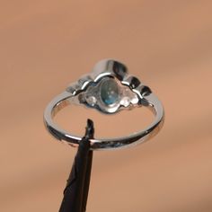 It is a London blue topaz ring. The main stone is 6 mm*8 mm oval cut.weight about 1.47 carats. The basic metal is sterling silver and plated with rhodium. To change the metal to a solid gold (white/rose) or platinum is also available, please ask for a quotation if you want. You can also go to my shop Home for more elegant rings: https://www.etsy.com/shop/godjewelry?ref=hdr_shop_menu London blue topaz is the November birthstone , More London blue topaz rings: https://www.etsy.com/shop/godjewelry? Oval Solitaire Blue Topaz Ring, Oval Blue Topaz Solitaire Ring, Oval Blue Topaz Birthstone Ring For Anniversary, Oval Aquamarine Topaz Ring With Bezel Setting, Aquamarine Topaz Ring With Bezel Setting, Oval Blue Topaz Ring For Anniversary, Anniversary Topaz Ring With Oval Cabochon, Silver Oval Blue Topaz Rings, Oval Cabochon Topaz Ring For Anniversary