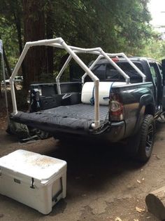 there is a truck with a bed on it and two coolers in the back