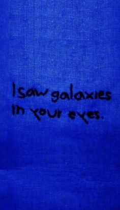 i saw galaxys in your eyes written on a blue cloth with black ink and writing