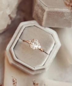 an engagement ring sitting on top of a box