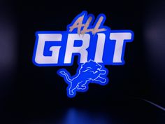 the detroit lions logo is lit up in blue and white with all grit on it