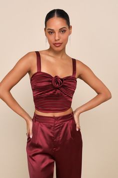 The Lulus Flawless Behavior Burgundy Satin Pleated Rosette Tank Top is a perfectly flirty option for any special occasion or celebration! Sleek pleated woven satin shapes this too-cute top that features a cropped, twist-front bodice adorned with a removable rosette motif at the center and a subtle sweetheart neckline, all supported by adjustable tank straps. Smocking at the back allows for the perfect fit. Fit: This garment fits true to size. Length: Size medium measures 15.5" from adjustable st Flirty Sleeveless Satin Tops, Flirty Fitted Satin Tops, Flirty Satin Top For Party, Flirty Satin Tops For Date Night, Elegant Crop Top Camisole For Party, Rosette Top, Girl Wishlist, Bella Wedding, Top Satin