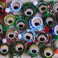 a bunch of christmas decorations are on the table together, with faces painted on them