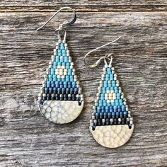 "These brick stitch and brass beaded earrings were handwoven with size 11/0 Miyuki delica glass seed beads. A time intensive and intricate craft, each bead is carefully hand stitched in order to create an even, uniform weave. The process requires focus, patience and dedication, as even a small pair of woven bead earrings can take hours to complete. Handwoven Brick Stitch Beadwork Miyuki delica glass seed beads  Sterling silver ear wires and findings silver plated brass components Extra durable nylon beading thread Each bead is approx. 1.6mm x 1.3mm Size: 2\" long (including ear wire) and 3/4\" wide Weight: 2g each (4g/pair)" Silver Teardrop Beaded Earrings, Handmade Blue Heishi Beads Earrings, Artisan Blue Beaded Earrings With Tiny Beads, Brass Components, Beading Thread, Star Light, Earring Ideas, Silver Moon, Glass Seed Beads