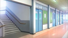 an empty hallway with stairs leading up to the second floor and green doors on each side