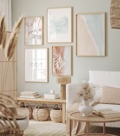 a living room filled with lots of pictures on the wall above a couch and coffee table