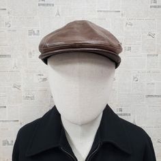 - Classic ivy flat ascot cap style to provide sleek and refined look - Made with vintage leather to give worn, broken in taste - Available in black and brown - Available in S/M (56-57cm) or L/XL (58-61cm) with an elastic sweatband to provide a comfortable fit - Hand-sewn exquite metal Emstate trim - Sewn Visor - Please note wrinkles and variations in color within the cap are part of the intended design and look and is not a defect - All Emstate products are proudly manufactured in USA. - Please Vintage Leather Hat With Flat Bill, Vintage Leather Hats For Winter, Vintage Leather Flat Bill Hat, Vintage Leather Winter Hats, Classic Brown Flat Cap, Classic Brown Beret With Curved Brim, Vintage Brown Beret Flat Cap, Classic Brown Beret For Fall, Classic Adjustable Beret For Outdoor