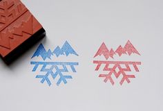 two snowflakes are next to a rubber stamp