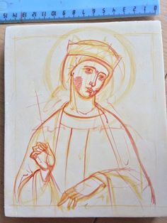 a drawing of the virgin mary is shown on a piece of paper next to a ruler