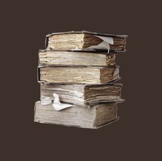 a stack of old books sitting next to each other on top of a brown background