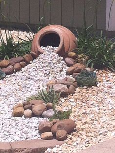 a garden with rocks and plants in it