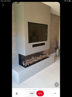 a flat screen tv mounted to the side of a wall next to a fire place