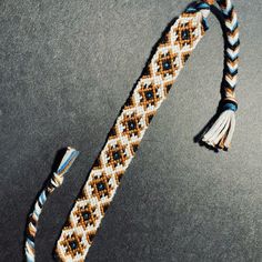 a close up of an odd looking object on the ground with beads and tassels