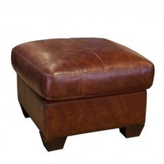 a brown leather ottoman with wooden legs