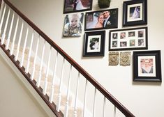 a staircase with pictures on the wall above it