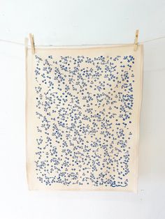 a white wall hanging with blue flowers on it