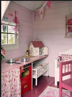 a child's play room with pink furniture and accessories on the walls, including a toy stove