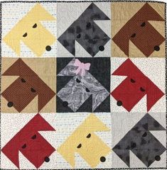 a quilt with many different colored dogs on the front and back pieces, including one dog's head