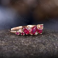 three pink tourmaline stone rings on top of a black rock with white and yellow diamonds