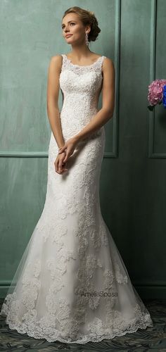 a woman in a wedding dress posing for the camera with her hand on her hip