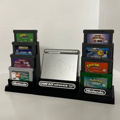 several nintendo games are stacked on top of each other in front of a white wall