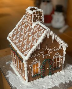 a gingerbread house is decorated with icing