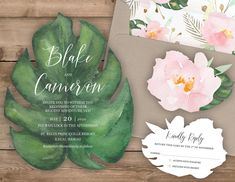 wedding stationery with watercolor flowers and greenery on the front, in shades of pink