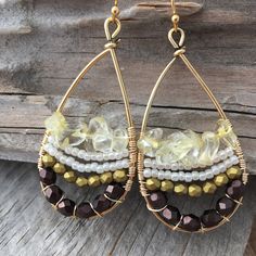 These fun earrings are made with a gold plated drop frame, tarnish-resistant gold plated copper wire, eggplant and gold faceted Czech glass beads, white Japanese seed beads, and citrine chip beads. The ear hooks are 14k gold-plated. These earrings measure 24x47mm and are lightweight. Colors do vary on different monitors; please keep this in mind. ~Care instructions: Not waterproof- do not wear while showering, swimming, etc. As with all jewelry, keep away from children and pets, and store in a d Wire Wrapped Czech Glass Drop Earrings, Handmade 14k Gold Filled Round Beaded Earrings, Bohemian Dangle Hoop Earrings With Copper Wire, Bohemian Beaded Earrings With Copper Wire, Bohemian Copper Wire Beaded Earrings As Gift, Bohemian Crystal Earrings With Faceted Beads For Gift, Bohemian 14k Gold-filled Beaded Earrings, Bohemian 14k Gold Filled Round Beaded Earrings, 14k Gold-filled Dangle Jewelry With Gold Beads