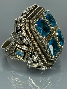 Embrace the allure of the past with our Mystic Aqua Blue Silver Ring. This striking piece is a nod to vintage sophistication, designed to stand out as a bold statement. Artisan-crafted with attention to detail, it features an enchanting green stone at its heart, complemented by intricate sterling silver work. We offer free ring resizing service for our rings, all you need to do is leaving message after you complete your payment. Material=  925 Sterling Silver   Stone/Stones=Aquamarine Ring Size( Antique Sterling Silver Signet Ring For Ceremonial Occasions, Antique Sterling Silver Signet Ring For Formal Occasions, Silver Rings With Historical Design As Gift, Silver Rings With Historical Design For Gifts, Blue Vintage Sterling Silver Signet Ring, Vintage Blue Sterling Silver Signet Ring, Antique Sterling Silver Signet Ring, Vintage Signet Ring With Lost Wax Casting As Gift, Blue Antique Signet Ring For Formal Occasions