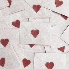 lots of small red hearts on white envelopes