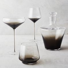 three glasses and a bottle on a table