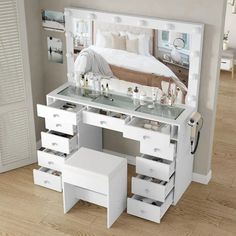 a white dressing table with drawers and mirror