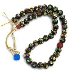 Eye Beads Recycled Glass Strand #31 Eye pattern is believed in many cultures to protect the wearer from the Evil Eye, misfortune, negativity, dark magic, malice and disease. Hand wound inlaid recycled glass with hand inlaid "Eyes" Bead Size Approx. 12mm Strand Length Approx. 22" Handcrafted in the Master Art Glass Workshops of Java, Indonesia Handmade Glass Beads In Black, Handmade Black Glass Beads, Spiritual Recycled Glass Beads For Gifts, Handmade Spiritual Glass Beads, Spiritual Handmade Glass Beads, Spiritual Glass Beaded Festival Necklaces, Spiritual Glass Beaded Necklaces For Festivals, Spiritual Glass Beaded Necklace For Festivals, Bamboo Beaded Curtains