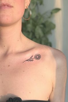 a woman with a flower tattoo on her chest